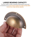 Person holding an Antique Brass Cabinet Handle Set 2 Pack Shell Drawer Pulls for Kitchen Cabinets Wardrobes and Furniture Replacement Hardware Accessory with Retro Look and An Easy Install Durable Metal Hardware That Delivers Classic Style and Solid Grip against a text background.