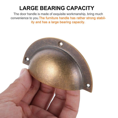Person holding an Antique Brass Cabinet Handle Set 2 Pack Shell Drawer Pulls for Kitchen Cabinets Wardrobes and Furniture Replacement Hardware Accessory with Retro Look and An Easy Install Durable Metal Hardware That Delivers Classic Style and Solid Grip against a text background.