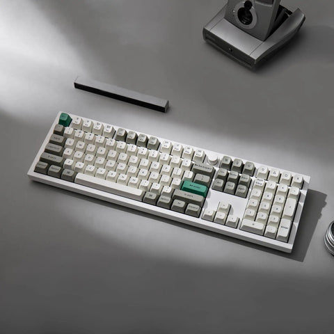 True Flex Full Size Custom Mechanical Keyboard With Hot Swappable Gateron Browns Qmk Via Firmware Bluetooth And 2.4Ghz Wireless Typing Rig RGB Backlit white keys on gray surface.