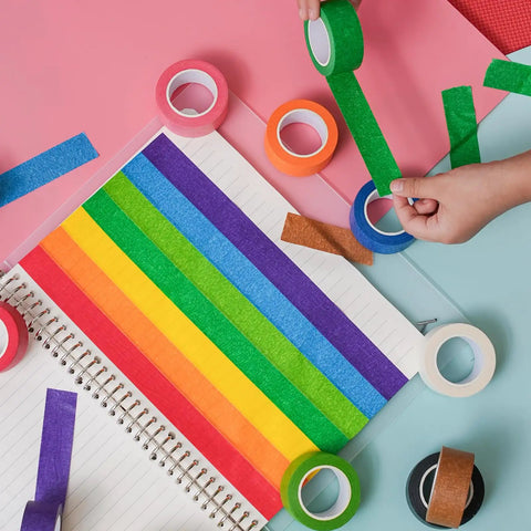 Rainbow Masking Tape Set With Twelve Rolls Of Colorful Painter Tape One Inch By Seven Hundred Twenty Feet Each on open notebook