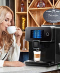 All Day Fully Automatic Coffee Machine With 19 Bar Pump And Built In Grinder Boasts Sleek Full Touch Lcd Interface, in use with a coffee cup.