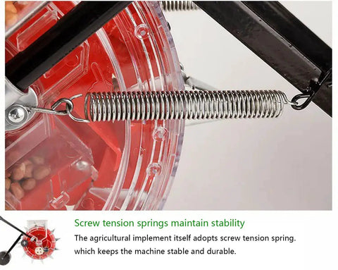 Close-up of spring mechanism on Manual Seed Seeder Handheld For Garden And Farm Use, showing red clear hopper and metal spring detail