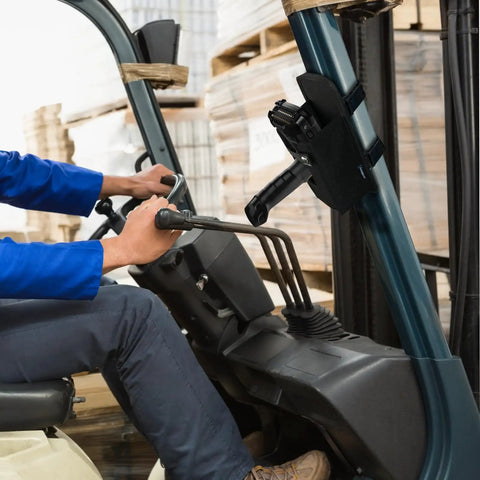 Rugged Barcode Scanner Holster With Ballistic Nylon Carrying Case For MC3300 attached to forklift, in warehouse setting.