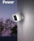 Keep Your Place Protected With This Wireless Smart Outdoor Security Camera Solar Powered 1080p Hd Color Night Vision Two Way Mic Built In Motion Siren And Battery Backup For Quick Porch Setup White mounted on wall with plug-in power.