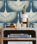 Wooden shelf with books in front of Denim Blue Feather Flock Peel And Stick Wallpaper Removable Self Adhesive For Walls And DIY Decor No Glue Needed Mess Free Application Made In USA 20.5 X 16.5 Ft featuring bird design.
