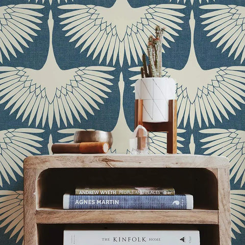 Wooden shelf with books in front of Denim Blue Feather Flock Peel And Stick Wallpaper Removable Self Adhesive For Walls And DIY Decor No Glue Needed Mess Free Application Made In USA 20.5 X 16.5 Ft featuring bird design.