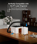 D5 Laser Engraver Air Purifier For P1 5W Mini Smoke Purifier on a table in a room with a flexible hose and compact design.