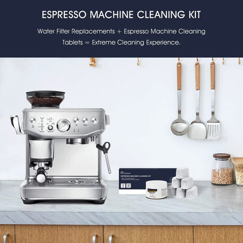 Front view of a stainless espresso machine with possiave cleaning kit box, six white tablets, and water-filter components on a marble counter.