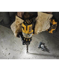 Heavy Hitter 20 Volt Max Brushless Cordless Hammer Drill Kit in use, drilling into concrete with metal bits.