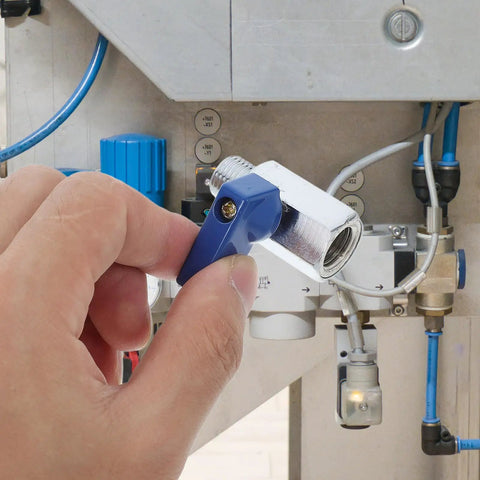 A hand holding a blue lever of Heavy Duty Brass Pneumatic Mini Ball Valve Shut Off With Npt 1/4 Inch Threads For Smooth Garden And Home Plumbing Pipe Control No Sweat Install Durability.