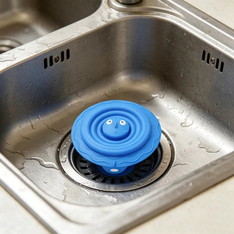 Drain Unclogger Flexible Bath Drain Cover Sealing Stopper in blue silicone on stainless steel sink, ready for use.