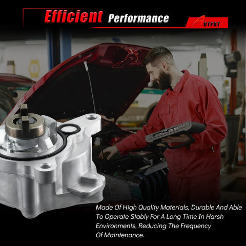 Automotive vacuum pump with silver aluminum body, held by mechanic in red coveralls beside an open-hood car.