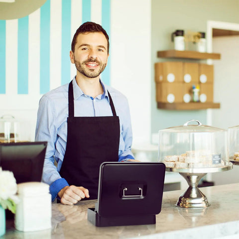 Barista with a Beefy Locking Cash Box With Money Tray For Cash Registers on countertop in a café setting.