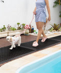 Woman walking dog on Anti Fatigue Rubber Floor Mat For Restaurant And Kitchen Durable Drainage Outdoor Doormat No Slip For Bars And Commercial Use Black 36 By 60 Inches Heavy Duty Workhorse Non Slip Entrance Mat For High Traffic Areas by pool.