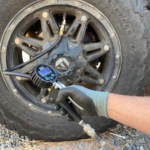 FlowPro 2.0 Digital Tire Inflator With Pressure Gauge 200 PSI ANSI Grade 1A Accuracy being used on a vehicle tire