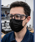Close-up of a man wearing Slick Anti Fog Safety Glasses With Built In Side Shields, ANSI Z87.1 Certified, in workshop setting.