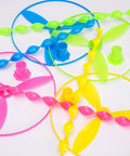 Colorful components from 40 Piece Large Flying Disc Toy Set with swirly sticks, rings, and plastic propeller spinners for kids
