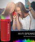 Two women enjoying music with 24W Bluetooth Speaker With Deep Bass And Dual Pairing, IPX7 Waterproof, Bluetooth 5.3, LED Lights, 30 Hour Playtime.