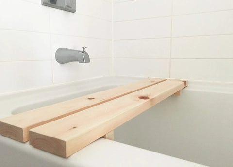 Hinoki Tub Bench Small For Bathroom Must Have, Water Ready Bath Stool Made From Japanese Cypress Hinoki Wood spans a white bathtub.