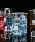 20 Pack 100 mL Glass Beaker Set Heavy Duty Lab Beakers With Printed Graduation For Lab Classrooms or Home Use, filled with liquids and ice.