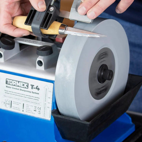 8 Inch SG-200 Grindstone 220-1000 Grit For T-3 And T-4 Sharpening Systems in use with a knife, showing fine surface finish on blade.