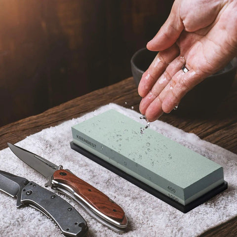 Actual Grit Whetstone Set With 400 1000 3000 8000 Grits for knife sharpening, knife and hand pouring water on grey stone