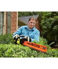 Man using 22 Inch Cordless Hedge Trimmer With 18 Volt Power Delivers Beast Mode Performance In A Lightweight Easy To Maneuver Package
