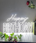 Big Birthday Neon Sign For Wall Decor With Dimmer Switch, 12V Reusable Light Up Birthday Party Decoration on tabletop with plants