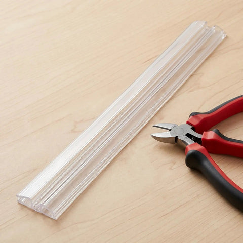 Clear Acrylic Piano Hinge Strips For Golf Cart Windshield Replacement Two Pack, shown with cutting tool on wood surface.