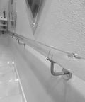 Get Ready To Level Up Your Space With This Epic Custom Acrylic Handrail Kit For Stairs Featuring Crystal Clear Lucite, Rock Solid Iron Brackets Supporting 440 Lbs Each, And A Grippy Non Slip Surface installed along a wall.