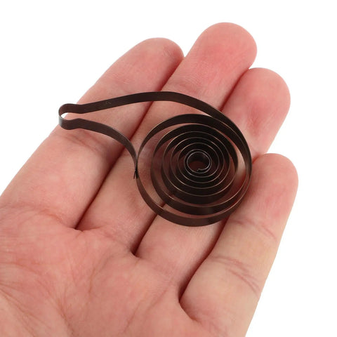 Mechanical Clock Spring For Alarm Clocks DIY Repairs And Craft Projects Replacement Component in hand