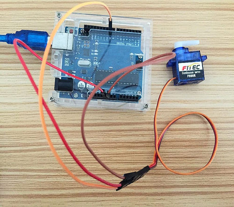 Geekstory Feetech FS90R blue continuous-rotation micro servo with RC tire wheel and orange wires (front view)