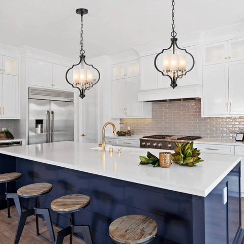 Modern Orb Chandelier With 3 Lights In Black And Gold, Frosted Glass Shades, illuminating a sleek kitchen island.