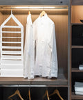Nine Compartment Hanging Closet Organizer With Heavy Duty Hook And Washable PVC Fabric For Super Handy Clothes Storage Multi Layer Wardrobe Bag To Keep Your Dresser Clutter Free And Hassle Free hanging next to white shirts in modern closet