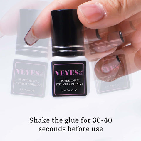 Extra Strong Lash Extension Glue 5ml bottle being held, label showing professional eyelash adhesive, instruction to shake before use