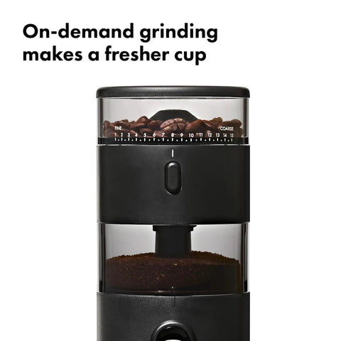 Compact Stainless Steel Conical Burr Electric Coffee Bean Grinder with beans and ground coffee visible in the hopper.