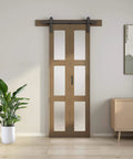 Bifold Glass Barn Door Kit 36 Inch with Hardware included, three-panel glass slab, installed in modern living room setting.