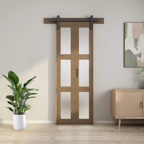 Bifold Glass Barn Door Kit 36 Inch with Hardware included, three-panel glass slab, installed in modern living room setting.