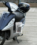 Durable Outdoor Waterproof Electrical Outlet Cover For Universal Charging Stations And Cord Storage Box seen on a scooter outdoors.