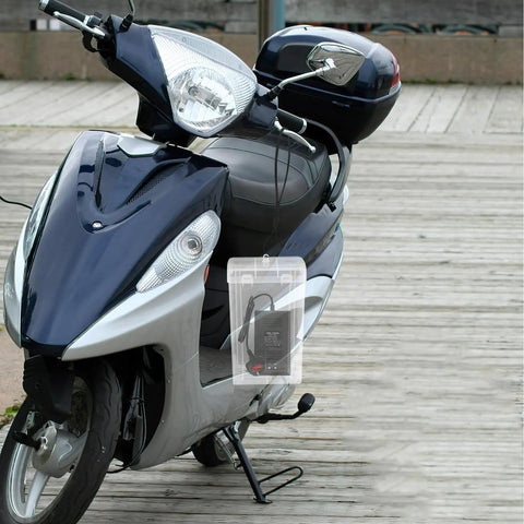 Durable Outdoor Waterproof Electrical Outlet Cover For Universal Charging Stations And Cord Storage Box seen on a scooter outdoors.
