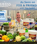 Man holding Heaven's Harvest products in city market setting; buckets and fresh produce visible.
