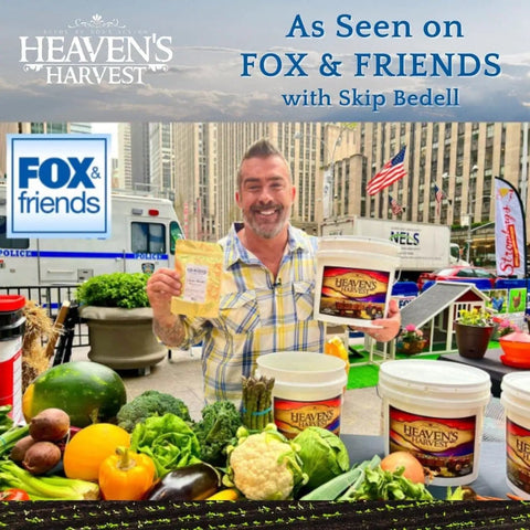 Man holding Heaven's Harvest products in city market setting; buckets and fresh produce visible.