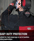Welder wearing Heavy Duty Leather Welding Jacket Built Tough For High Amperage And Out Of Position Work with sparks visible