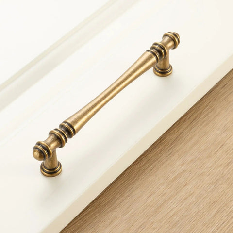 Slick Antique Brass Cabinet Pulls 10 Pack, 5 Inch Top Tier Solid Metal Drawer Handles For Kitchen Cabinets And Bathrooms, Smooth Grip Vintage Hardware Upgrade For Dressers And Home Projects, No Sweat Install Legit Craftsmanship showing close-up of brass handle.