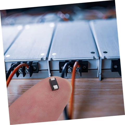 Heavy Duty US1K 1A 800V Rectifier Diodes 100 Pack Top Shelf Replacement For Automotive Alternators Power Supplies And Industrial Circuits, depicted on fingertip.