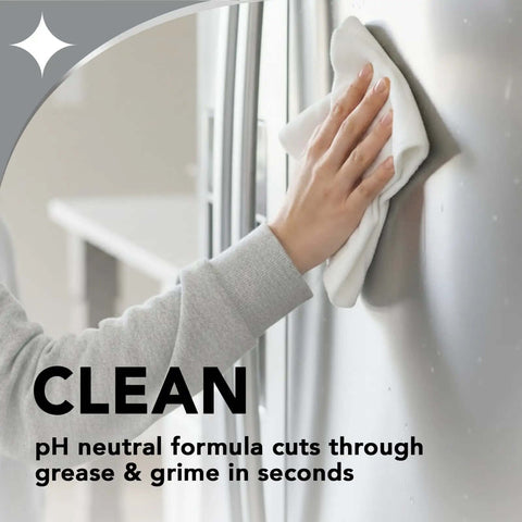 Person cleaning stainless steel appliance with Stainless Steel Cleaner And Polish Kit, 2 Pack With Anti Fingerprint Spray and Microfiber Cloths.