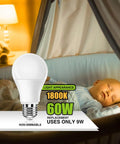Amber A19 Light Bulbs 9W 60W Equivalent Blue Light Blocking next to sleeping baby in a dimly lit nursery