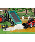 Manitou 3300V Skid Steer Loader Toy With Movable Bucket And Arm beside a dumped load of dirt, outdoor play scene