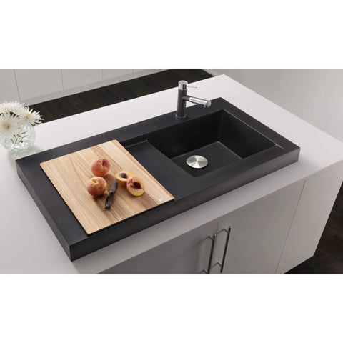 Modern kitchen sink with cutting board and fruit in upscale kitchen setting