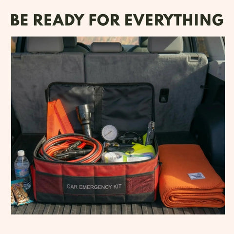 Car emergency kit and orange blanket in vehicle trunk, showcasing preparedness essentials for outdoor trips.